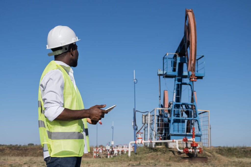 black-man-enters-information-tablet-about-jackpump-work-scaled